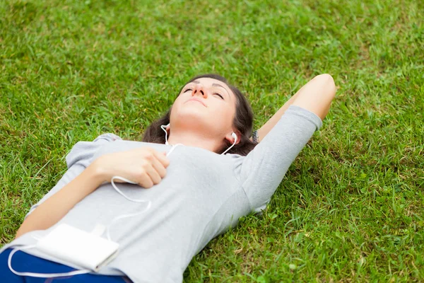 Woman relaxing while listening music — Stock Photo, Image