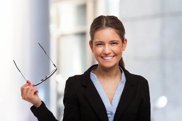 Woman holding her eyeglasses — Stock Photo, Image