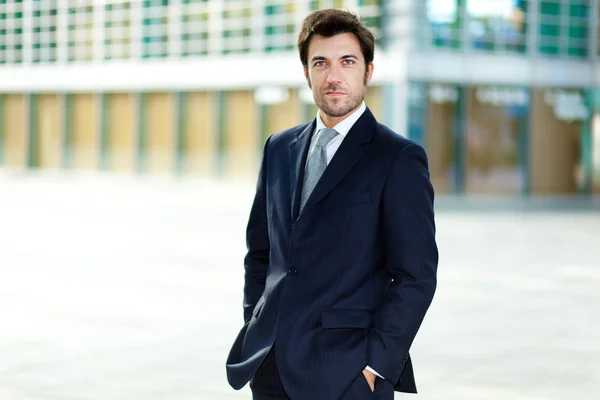 Businessman with hands in pockets — Stock Photo, Image