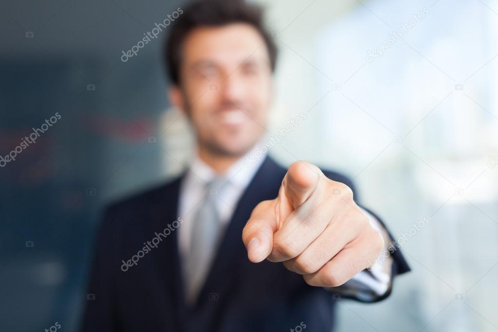 Businessman pointing his finger at you