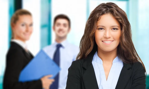 Businesswoman on the background of colleagues — Stock Photo, Image