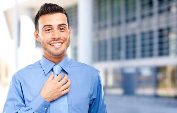 Businessman adjusting his necktie — Stock Photo, Image