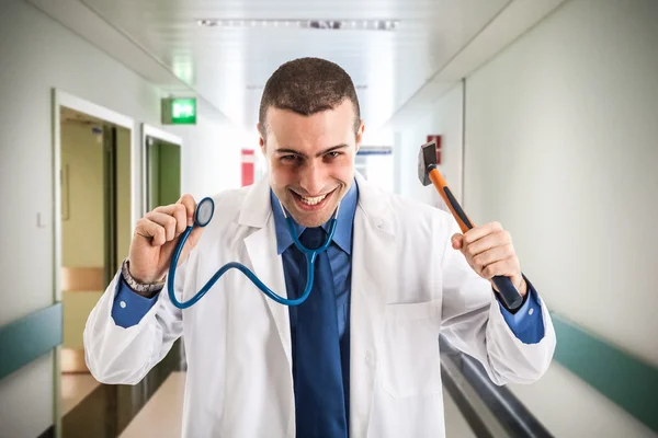 Doctor holding an hammer — Stock Photo, Image