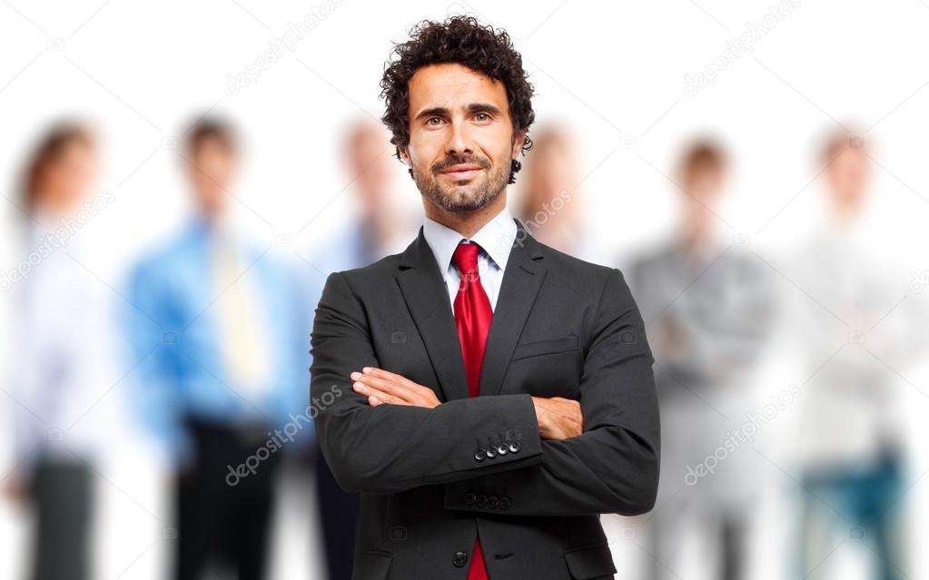 Businessman smiling with his arms folded