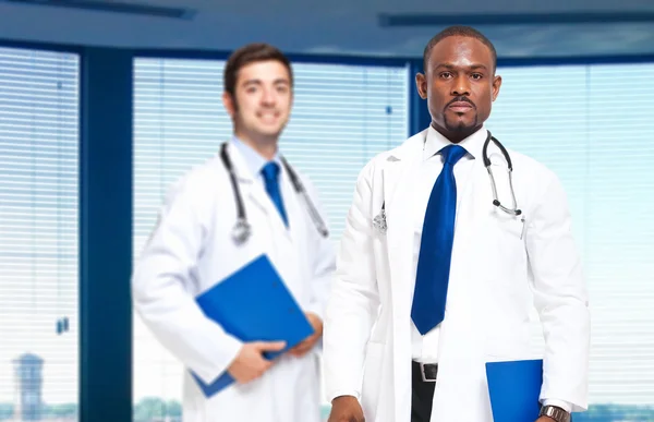Two friendly doctors smiling — Stock Photo, Image