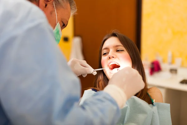 Woman receiving a dental treatment — Stock Photo, Image