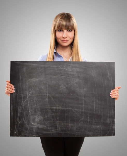 Woman holding blackboard — Stockfoto