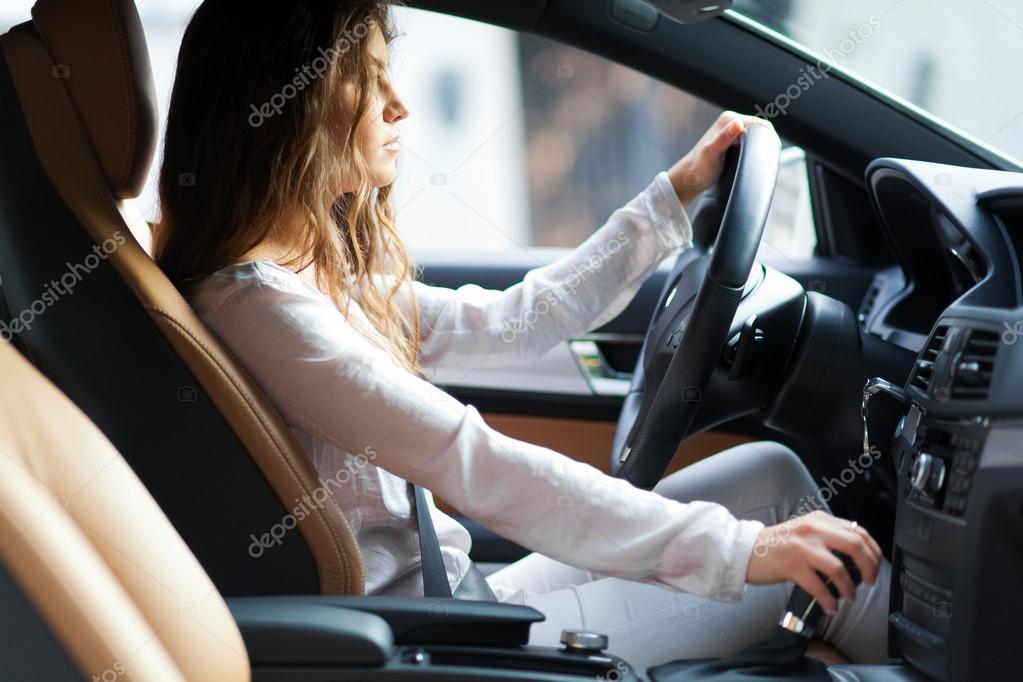 Young woman driving her car Stock Photo by ©minervastock 59864485