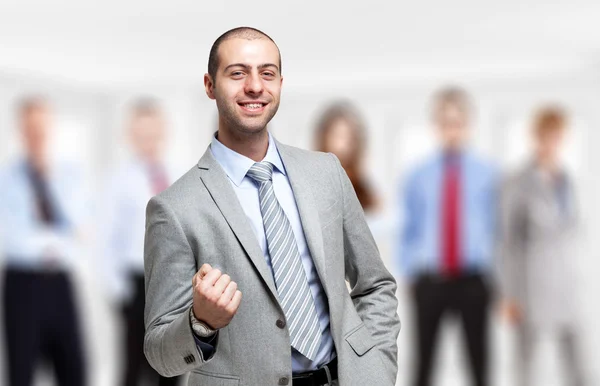 Happy man in front of a group of people — Stock Photo, Image