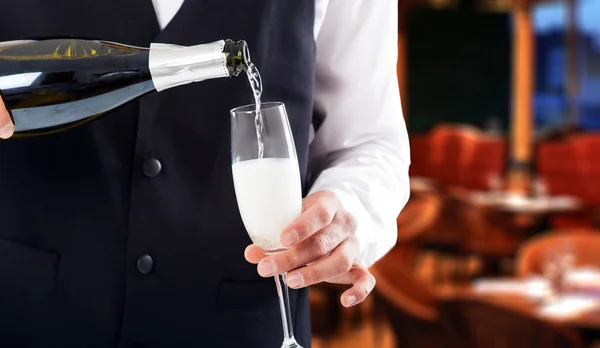 Waiter holding champagne bottle — Stock Photo, Image