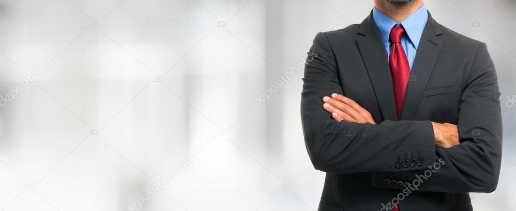 Businessman in suit with crossed arms
