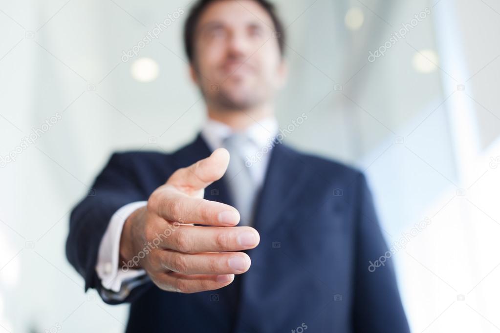 Businessman offering an handshake