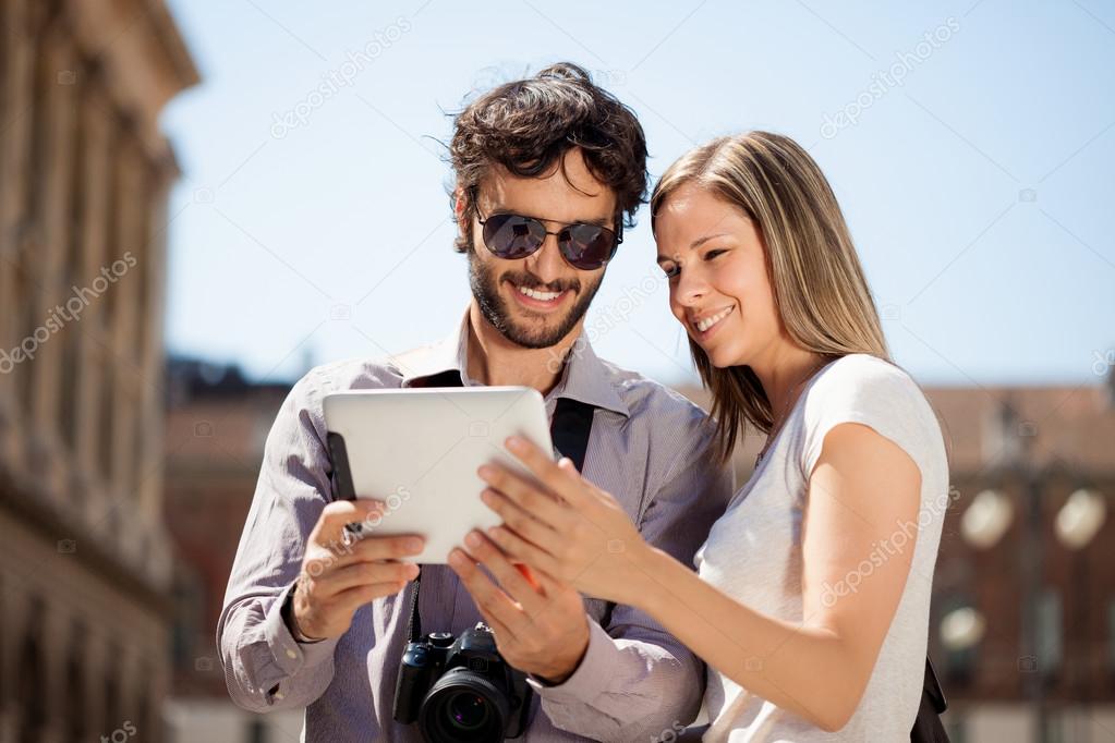 Tourists using digital tablet