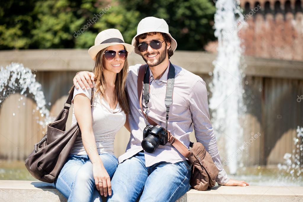 Tourists sitting near fountain