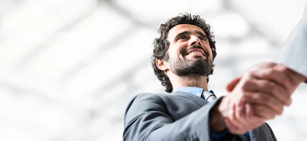 Businessman giving an handshake