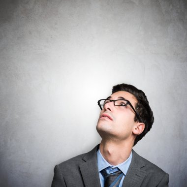 Genç iş adamı yukarı bakıyor.