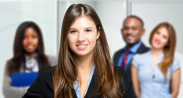 Businesswoman standing before team — Stock Photo, Image