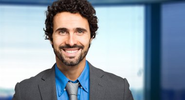 Ofisinde gülümseyen iş adamı.