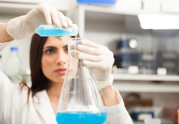 Scientist filling a flask — Stock Photo, Image