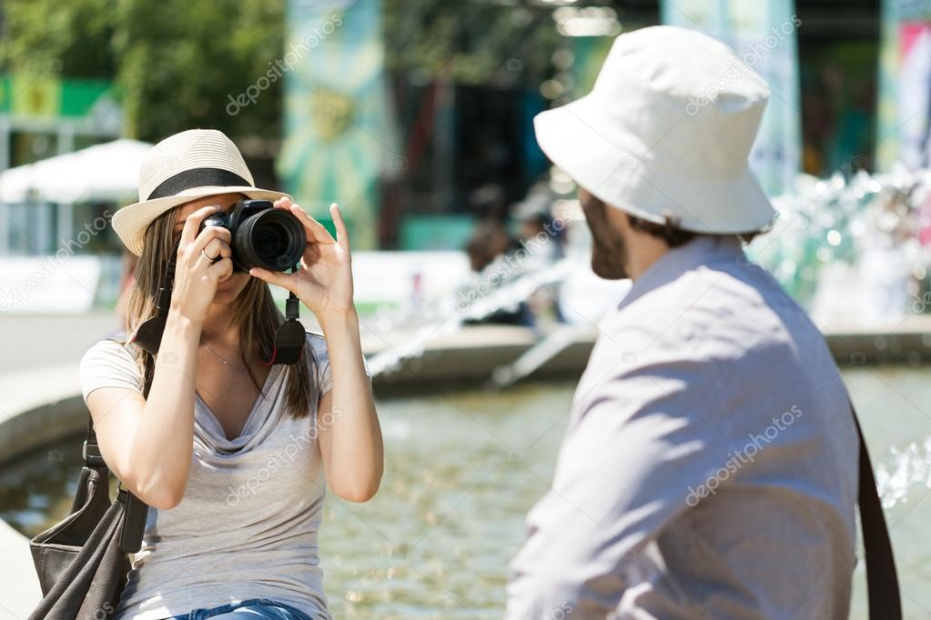 Woman taking picture of boyfriend