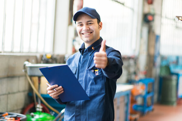 Worker in factory showing thumbs up