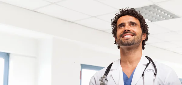 Smiling doctor in bright clinic room — Stock Photo, Image