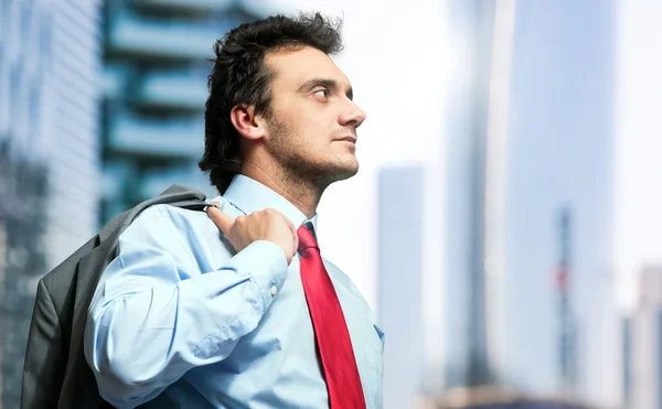 Young businessman holding his jacket — Stock Photo, Image