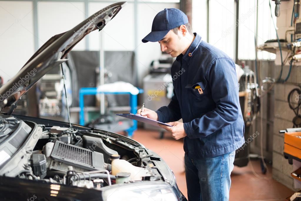 Mechanic at work in his garage — Stock Photo © minervastock 67629735