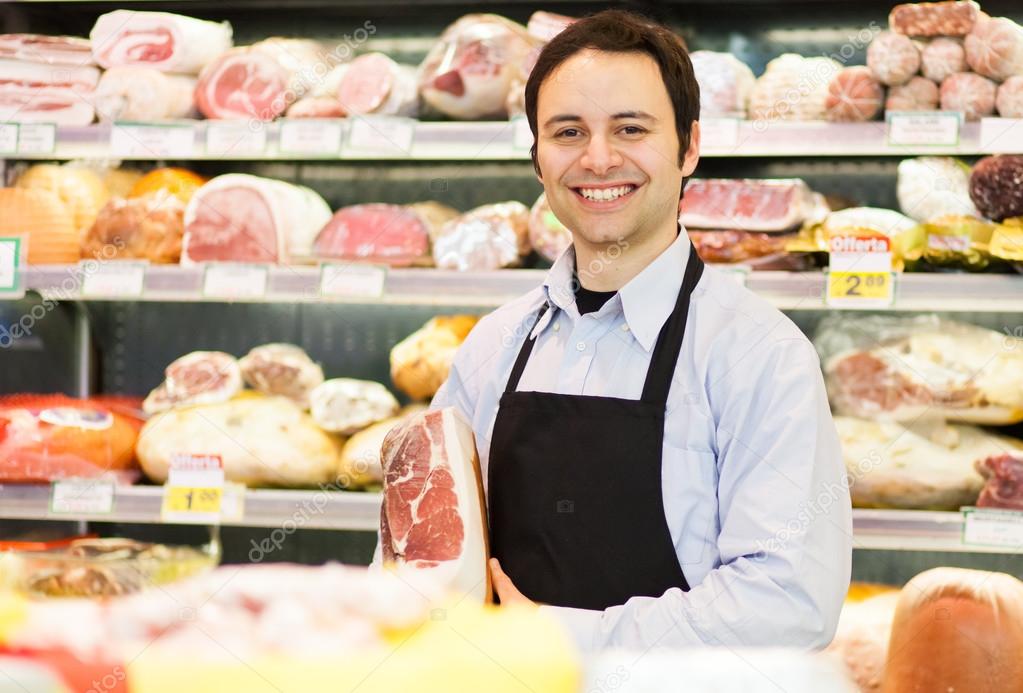 Storekeeper smiling in grocery store