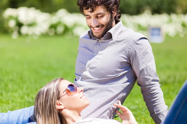 Gelukkige paar zitten in park — Stockfoto