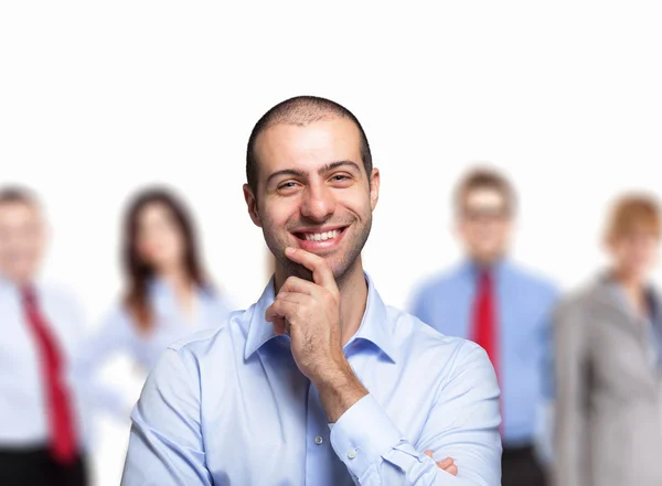 Smiling man in front of people — Stock Photo, Image