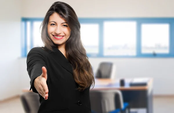 Smiling businesswoman giving hand — Stock Photo, Image