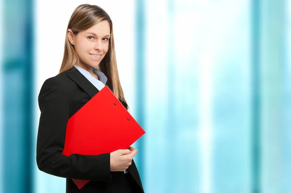 Young businesswoman holding clipboard — Stock Photo, Image