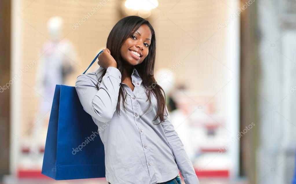 Black woman holding shopping bags