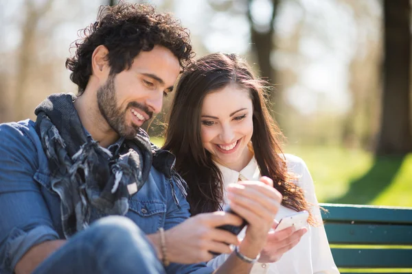 Muž ukazuje svůj telefon s dívkou — Stock fotografie