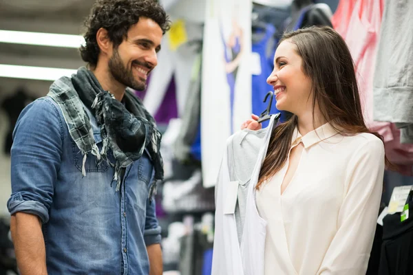 Couple shopping in a dress shop — Stock Photo, Image