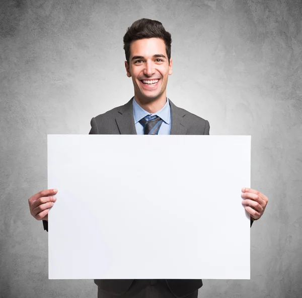 Businessman holding white board — Stock Photo, Image