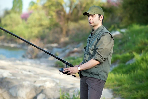 Pescatore che pesca su un fiume — Foto Stock