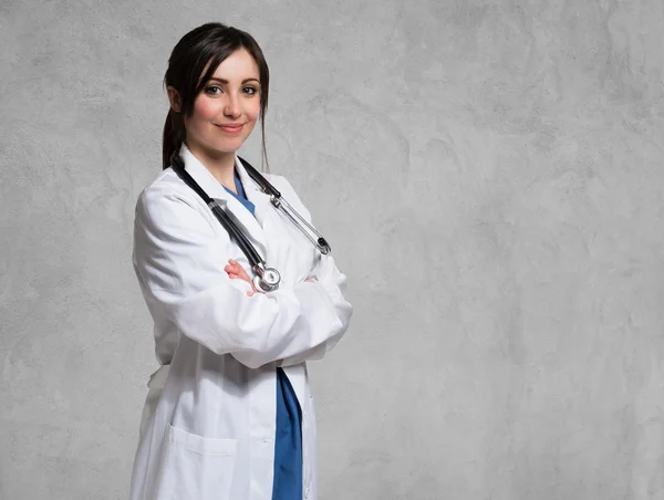 Smiling doctor against gray — Stock Photo, Image