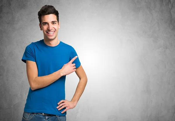 Smiling man pointing his finger — Stock Photo, Image