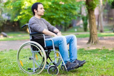 Paralyzed man using his wheelchair