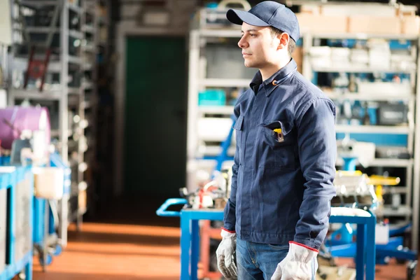 Young worker in his factory — Stock Photo, Image
