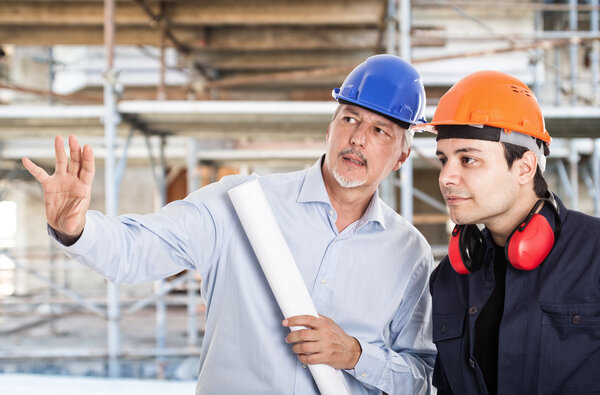 Architect explaining work to foreman