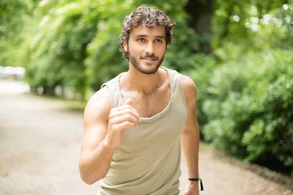 Couple running in a park — Stock Photo, Image