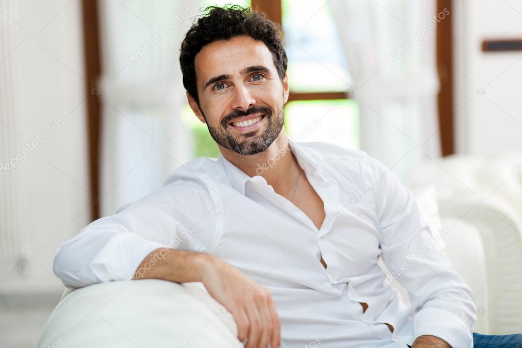 Handsome man sitting on  sofa