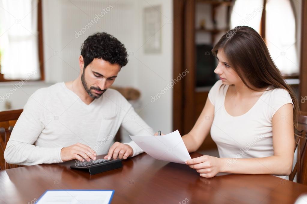 Couple calculating domestic bills at home