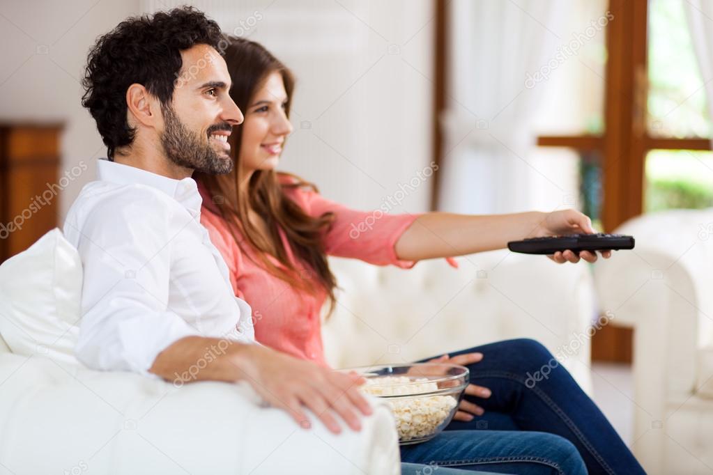 Couple watching tv on a sofa