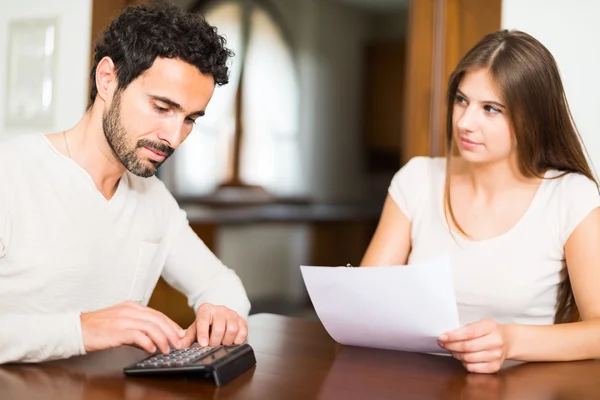 Couple calculating their expenses — Stock Photo, Image