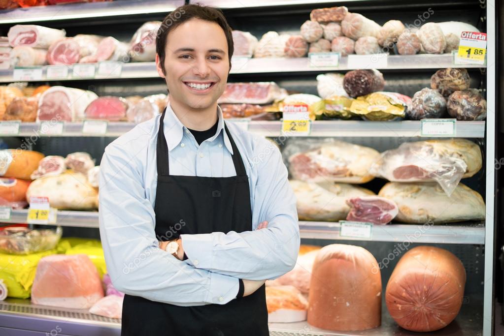 smiling shopkeeper in a grocery store