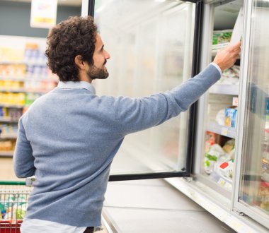 Man taking deep frozen food from freezer clipart